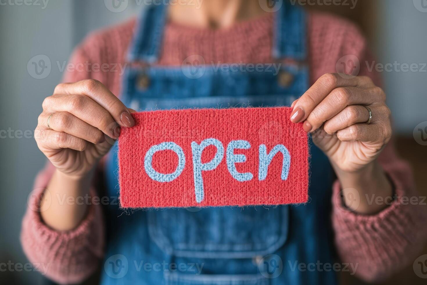 Hanging open sign displayed on glass door in a charming shop environment photo