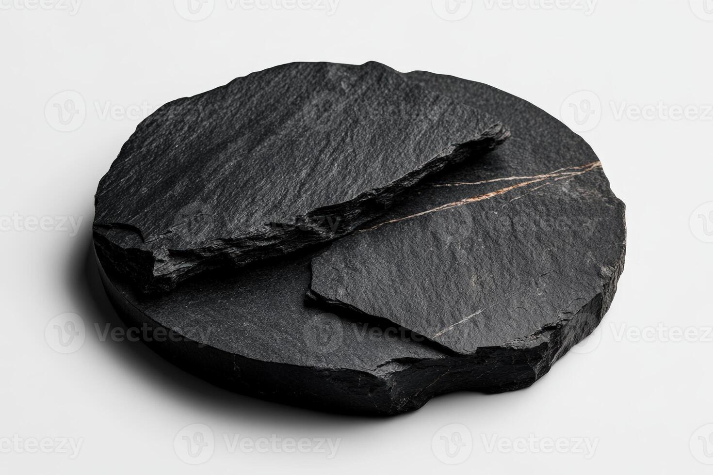 Natural black stone pieces arranged on a white surface for a minimalist aesthetic display photo