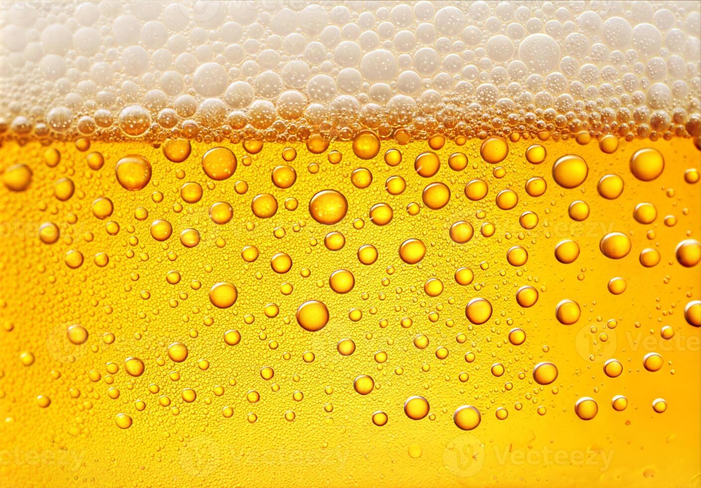Close Up of Golden Yellow Beer with Frothy Bubbles photo