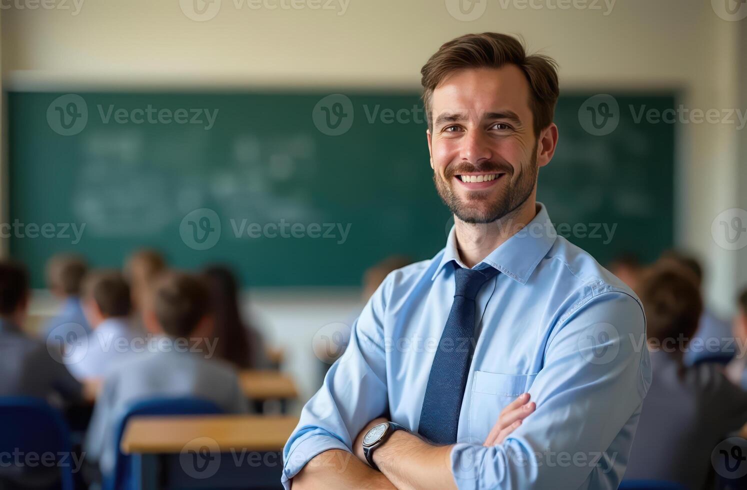Confident male teacher smiling in classroom with students focused on learning. teacher's Day, international workers day photo