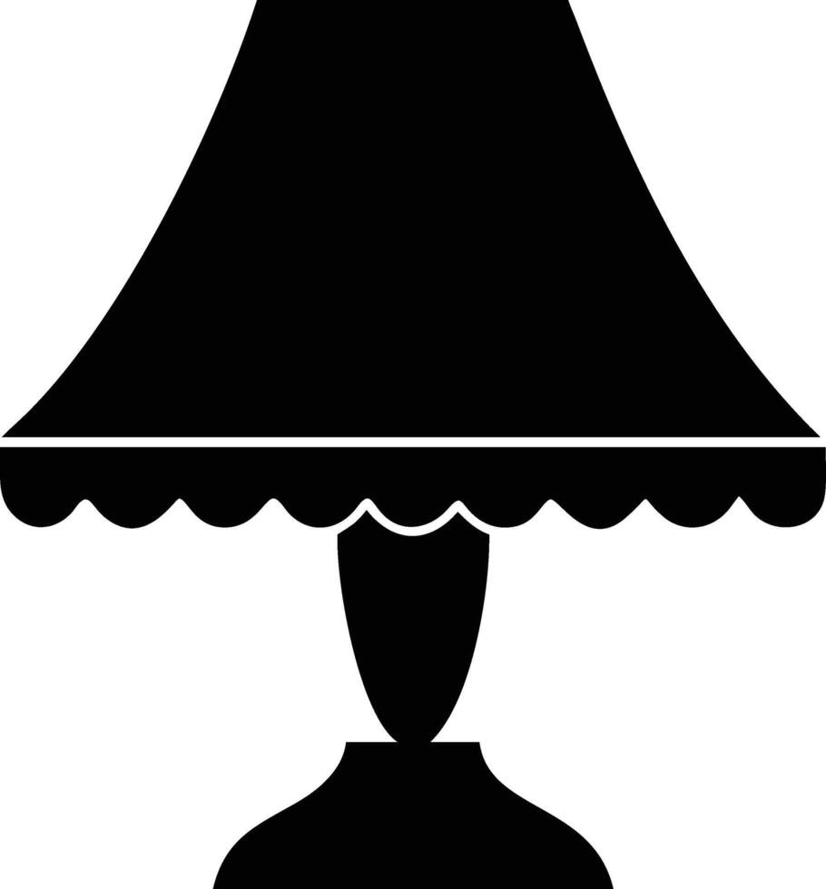 An antique black table lamp with scalloped shade evokes vintage charm and simplicity vector