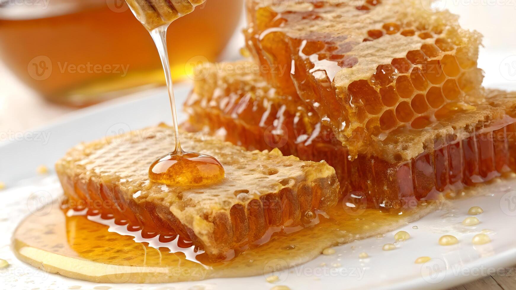 Honeycomb with dripping honey on a white plate for food photography photo