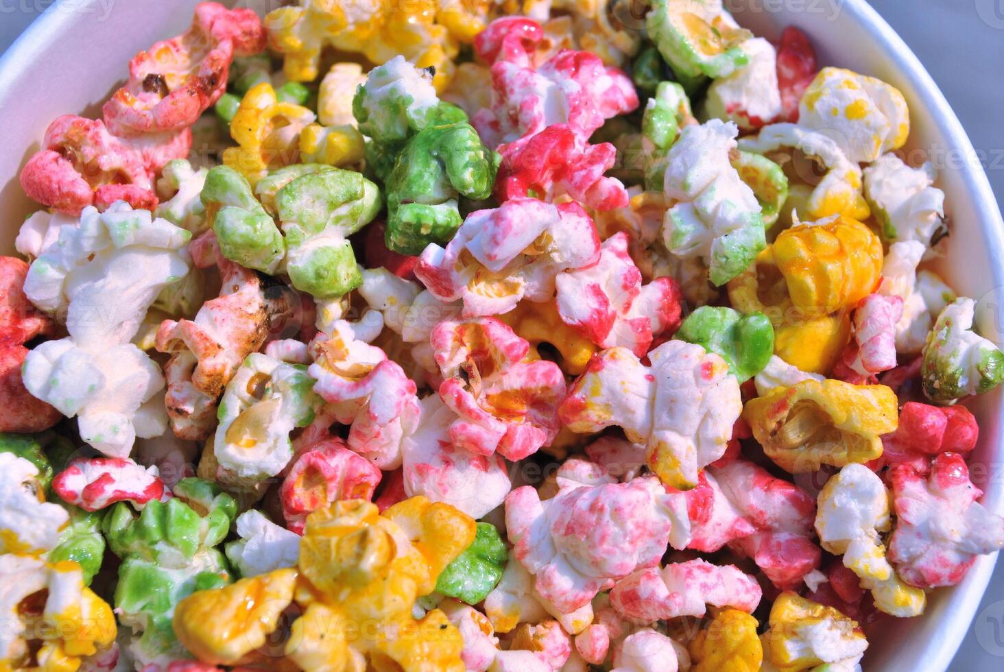 Colorful popkron in a cardboard bucket, close up plan photo