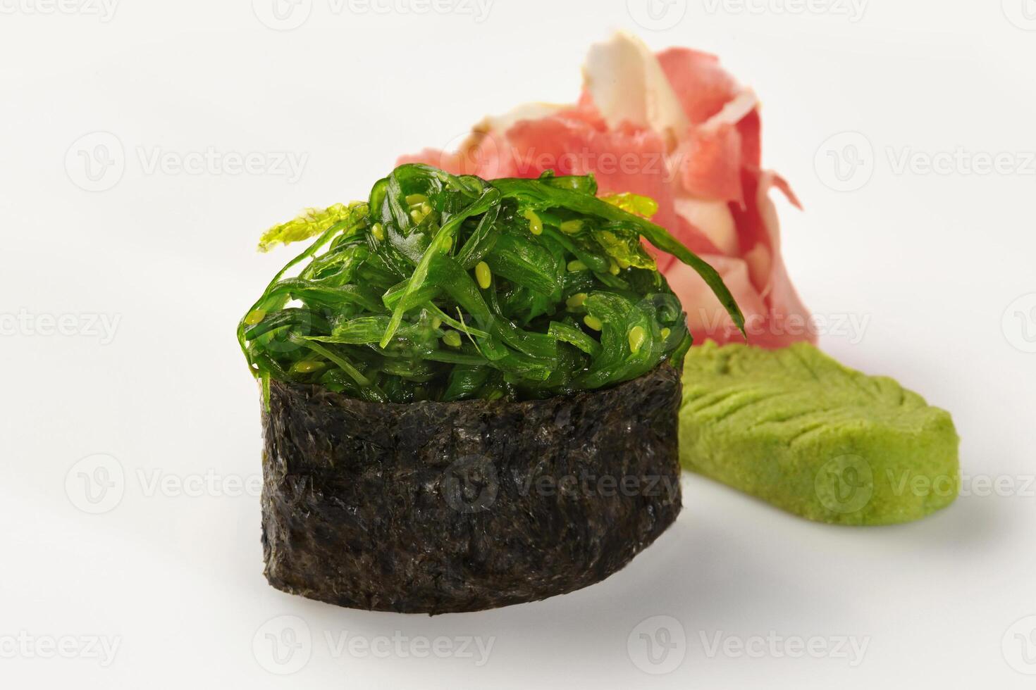 Gunkan maki sushi with chukka seaweed, pickled ginger and wasabi on white background photo