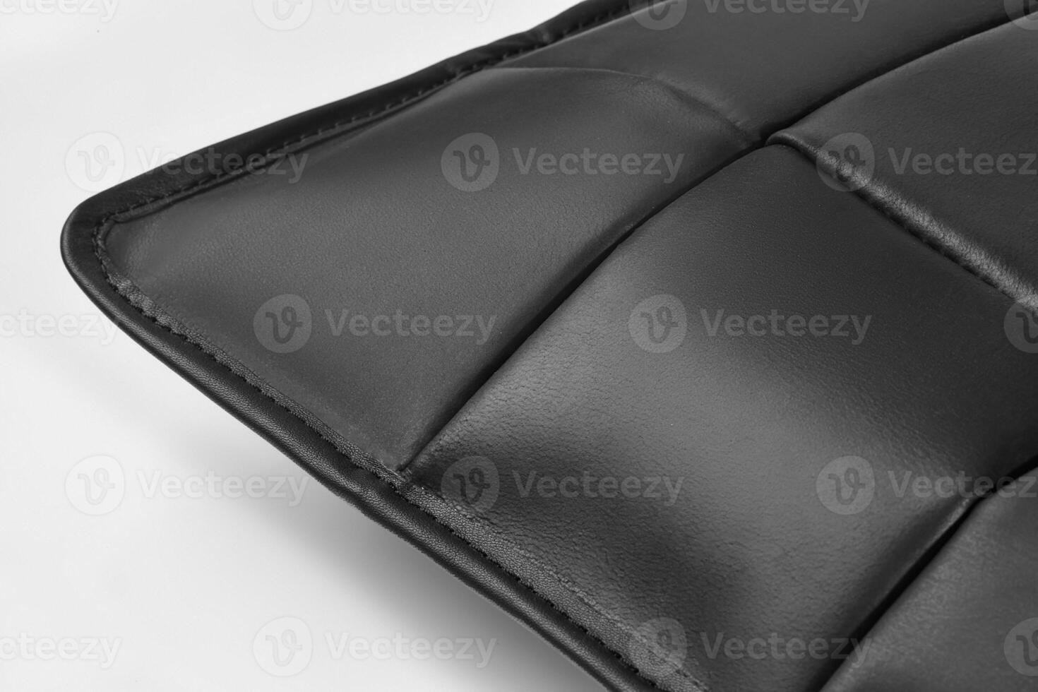 Close-up of black leather upholstery showing stitching and texture photo