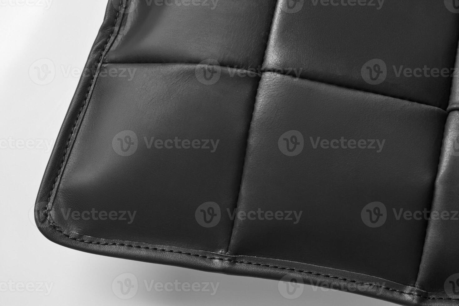 Close-up of black leather upholstery with decorative stitching detailing photo