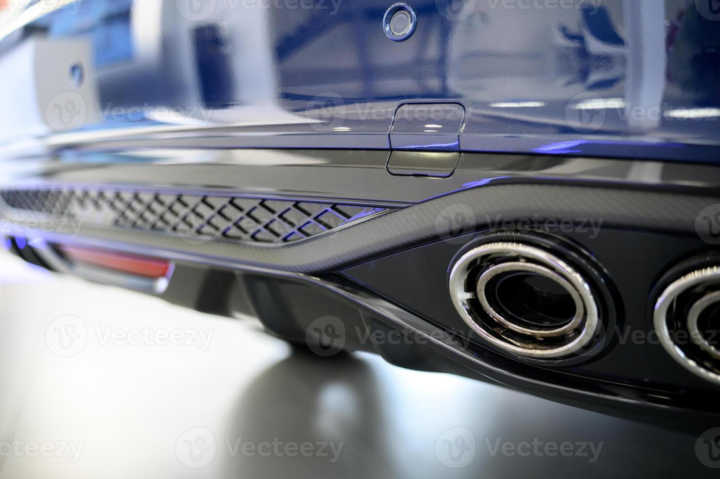 The exhaust pipes of a blue car photo