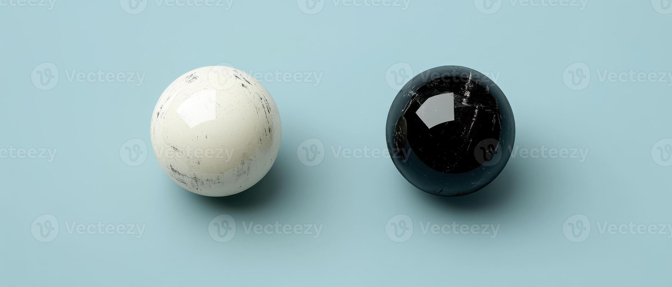 Yin and Yang concept with black and white spheres on a light blue background, representing balance, harmony, and duality photo