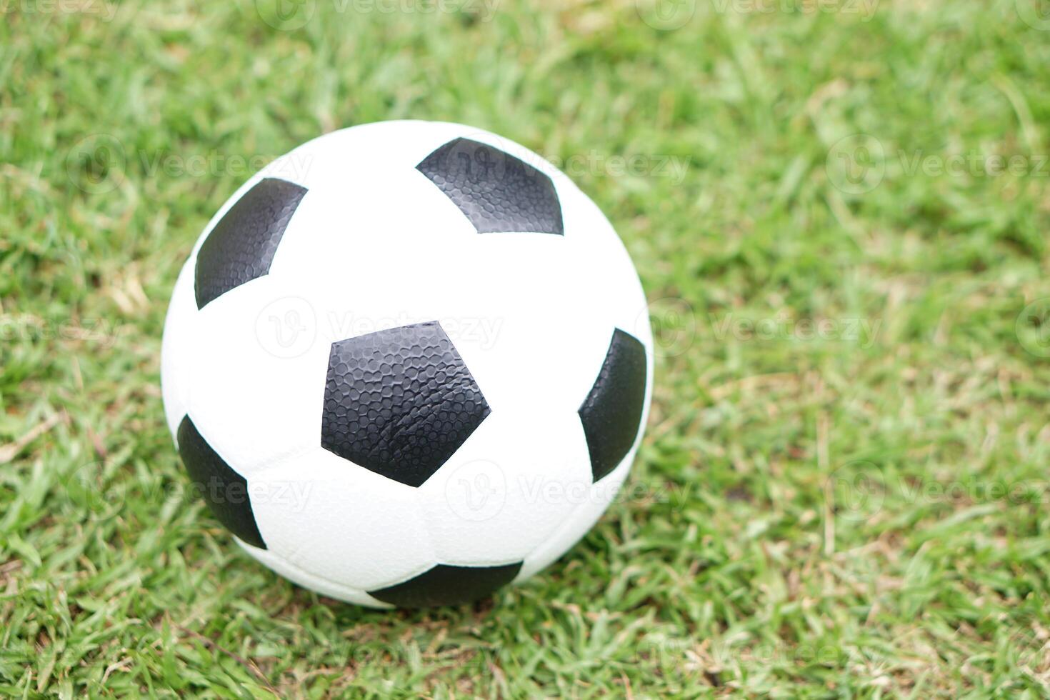 Football, soccer ball on green grass field background. Concept, Sport equipment. sport, workout, exercise for health. Hobby. Football match. photo