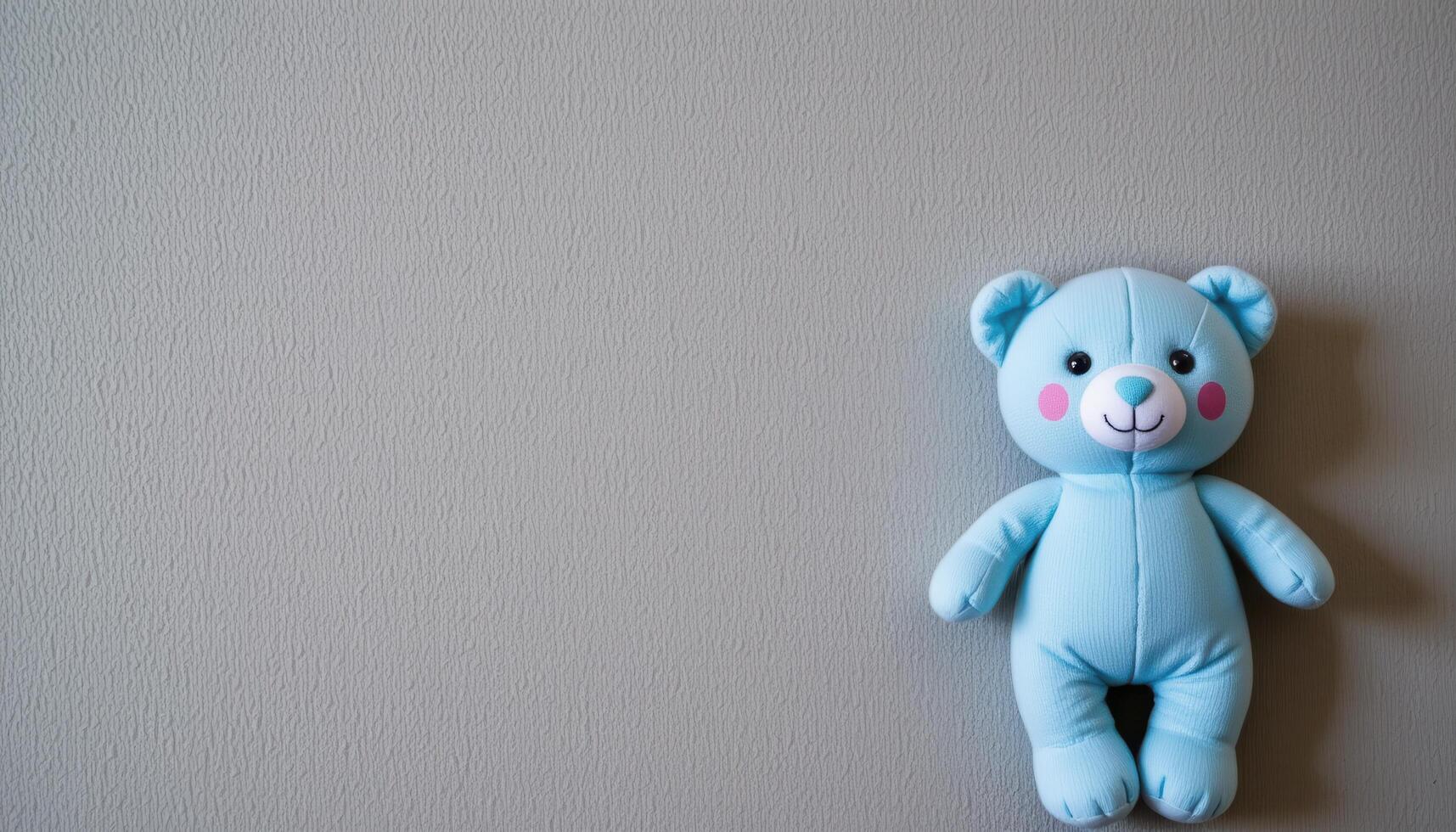 Gray vertical background with blue plush toy and empty space, baby boy birth concept vertical layout photo