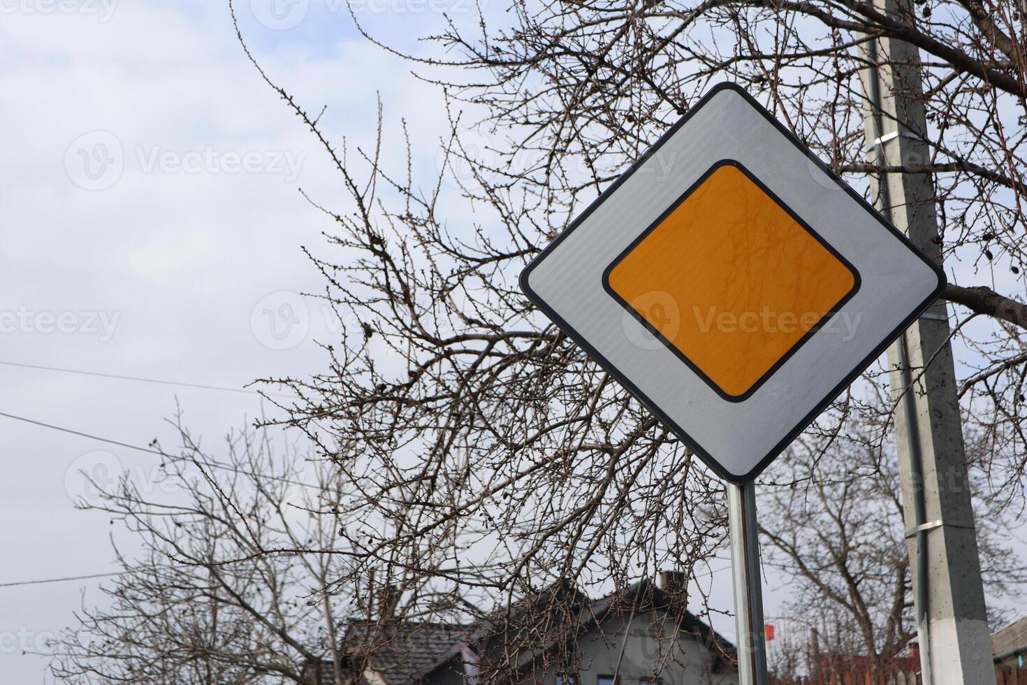 A Caution Traffic Sign Against a Dramatic Cloudy Sky, Emphasizing Safety and Awareness photo