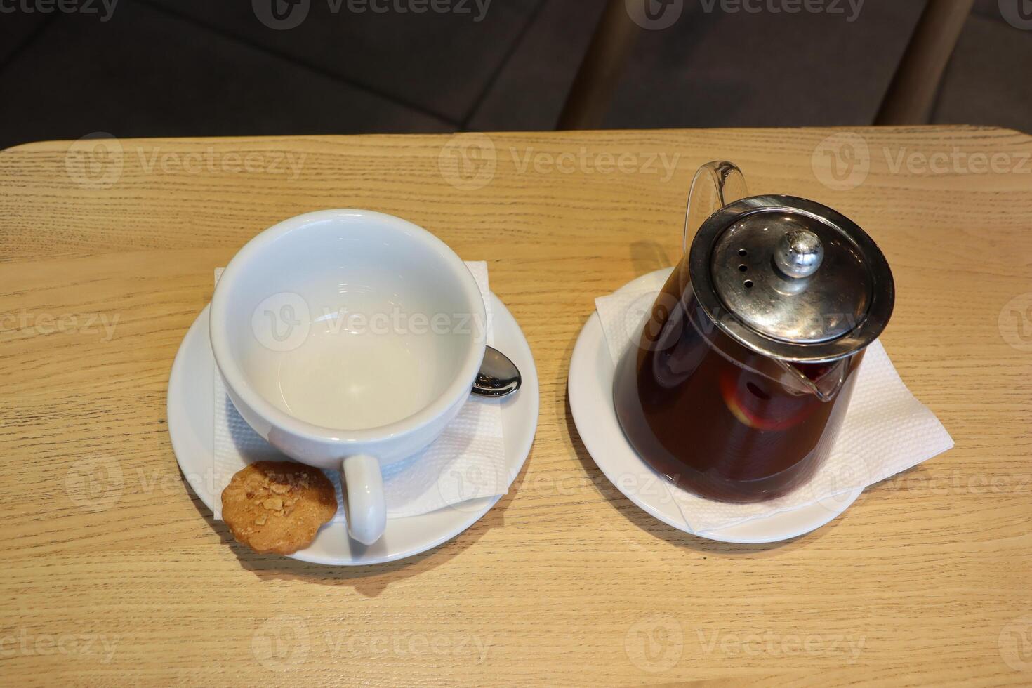 A delightful scene featuring tea and cookies elegantly arranged on a charming wooden table photo
