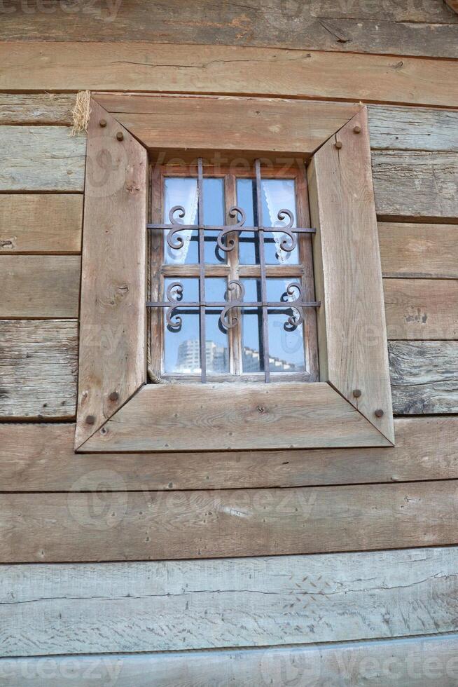 A Charming Rustic Window Featuring Beautiful Decorative Bars That Enhance Its Appeal photo