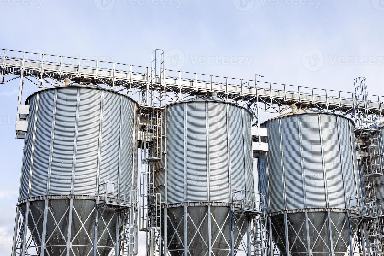 A group of metal silos on a farm photo