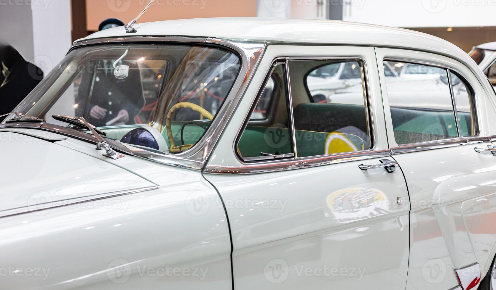 A classic car is on display at a museum photo