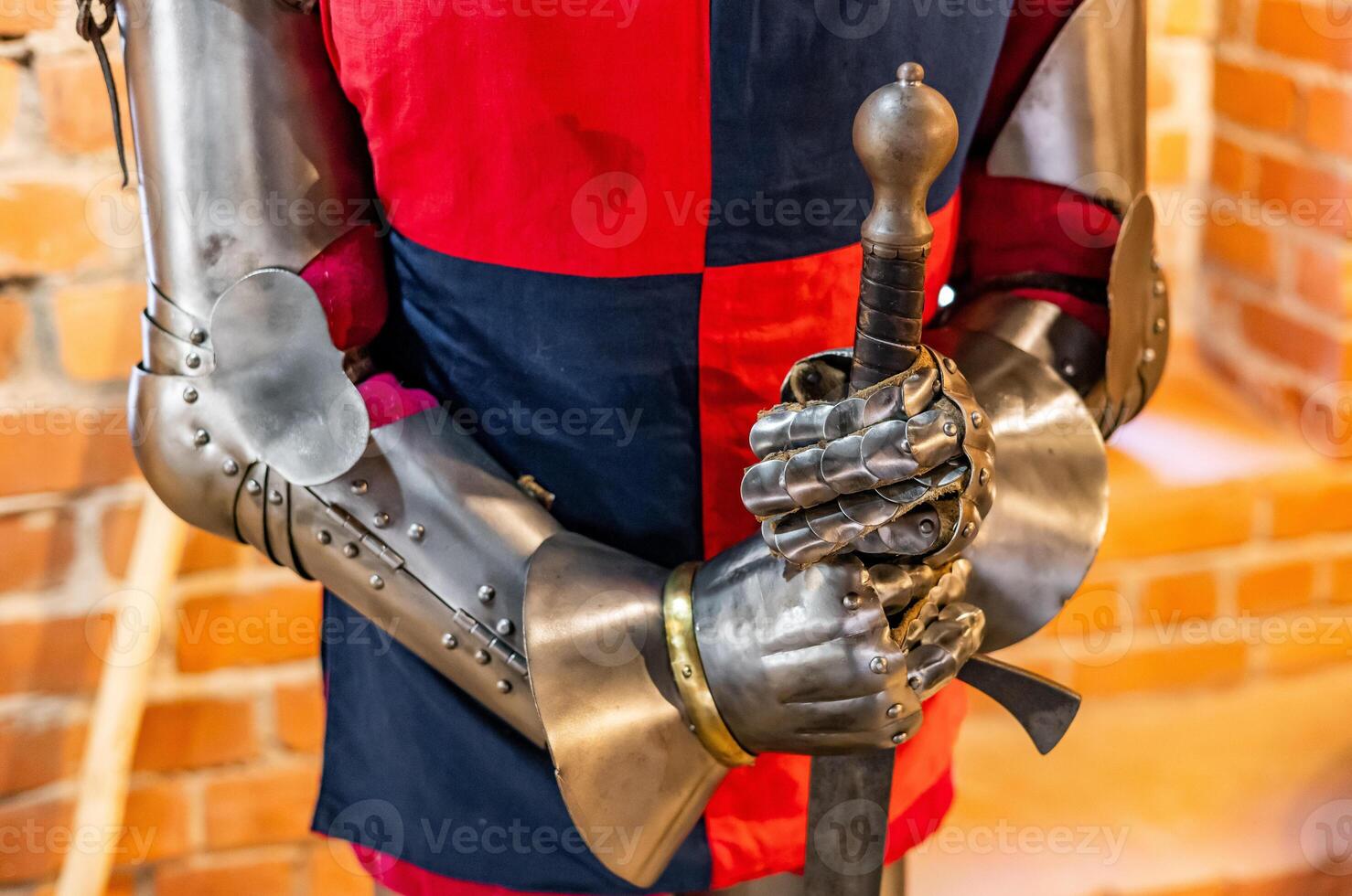 A man in a medieval armor holding a sword photo