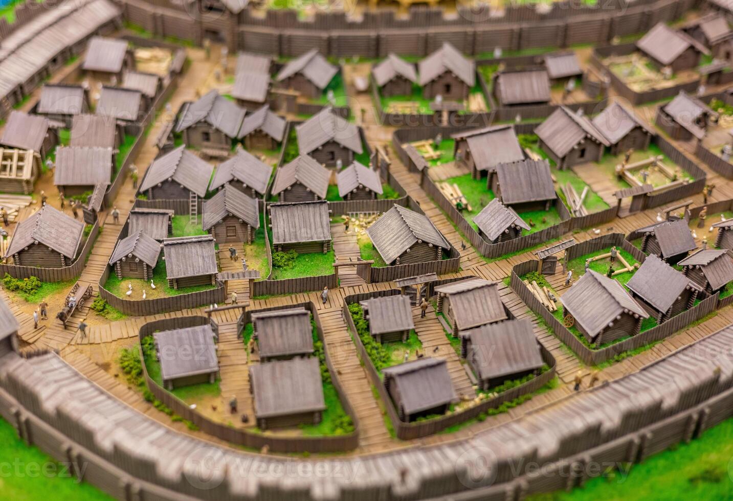 A model of a medieval town with a castle in the background photo
