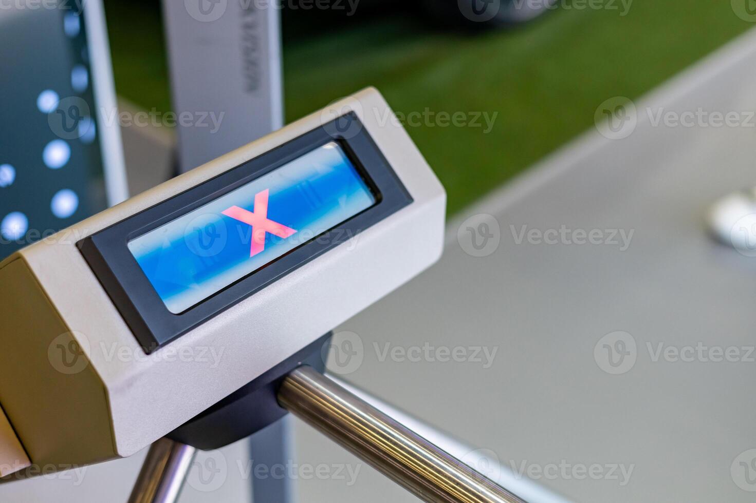 A person is standing in front of a metal detector photo
