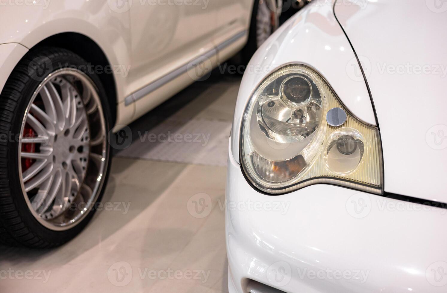 A close up of a white car with a headlight photo