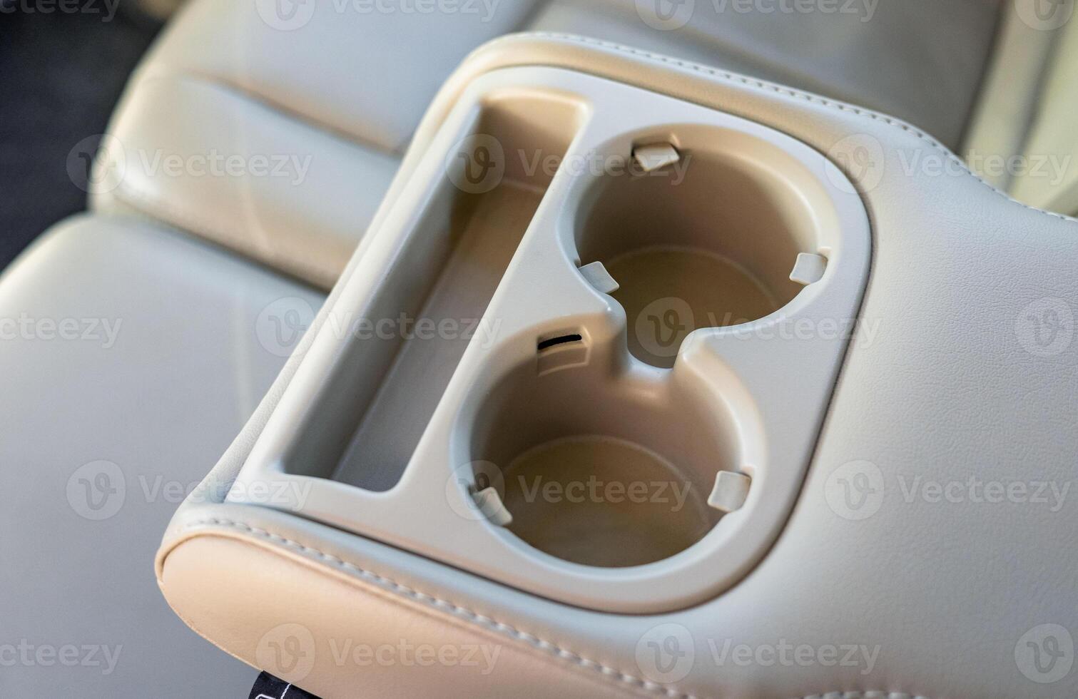 A car seat with two cups and a cup holder photo