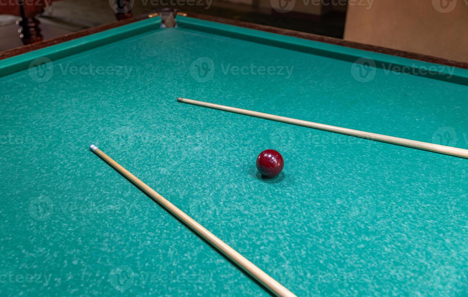 Pool table with billiard sticks and ball photo