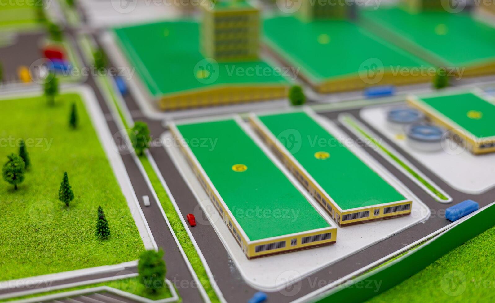 A model of a city with green buildings and roads photo