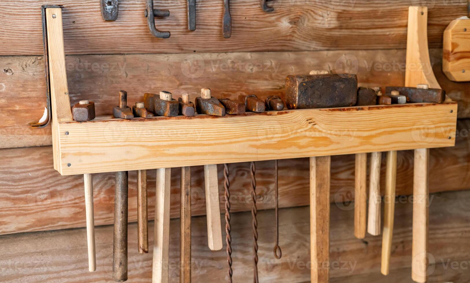 A wooden wall with tools hanging on it photo