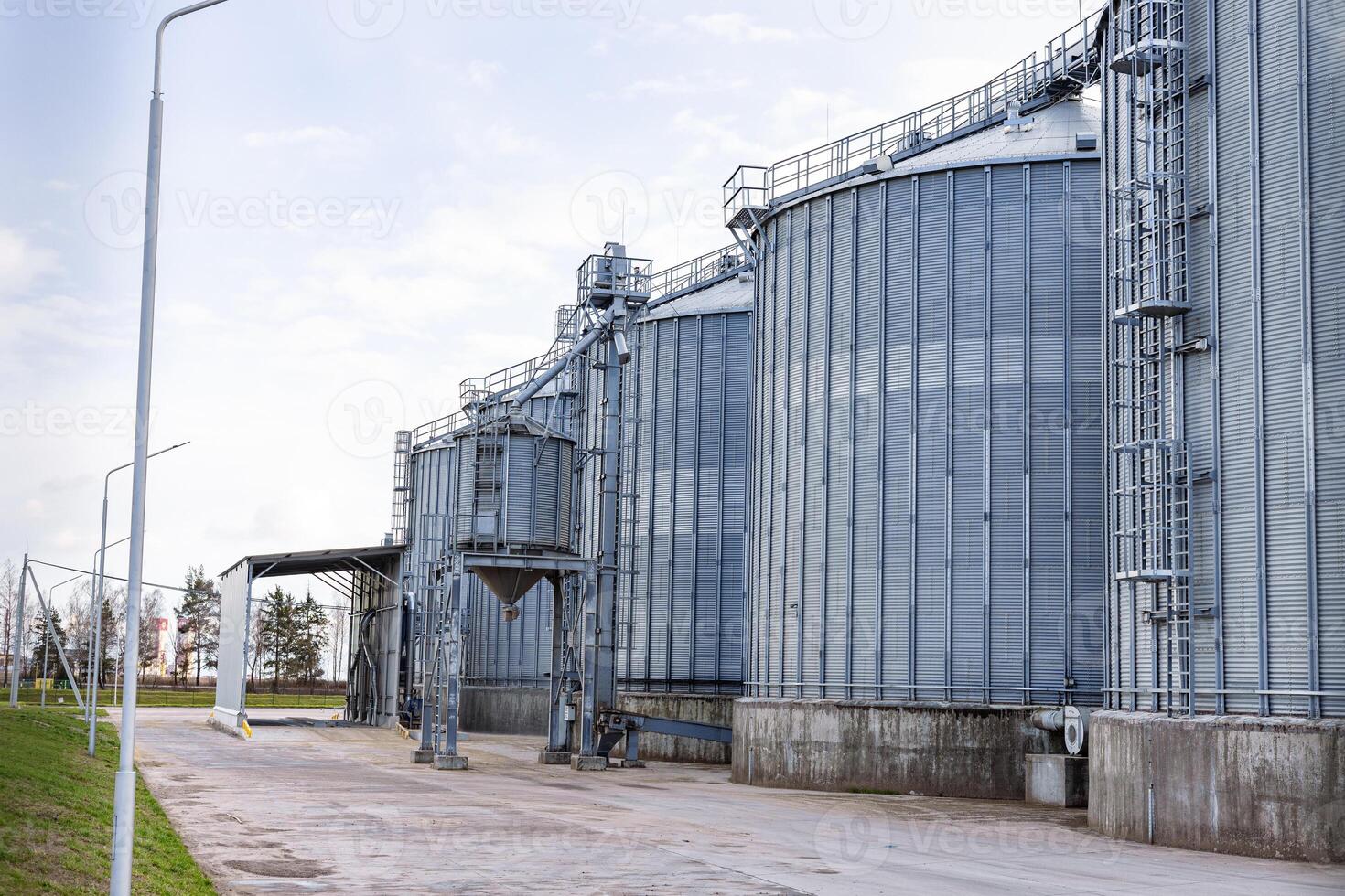 A large industrial building with a large silo on the side photo