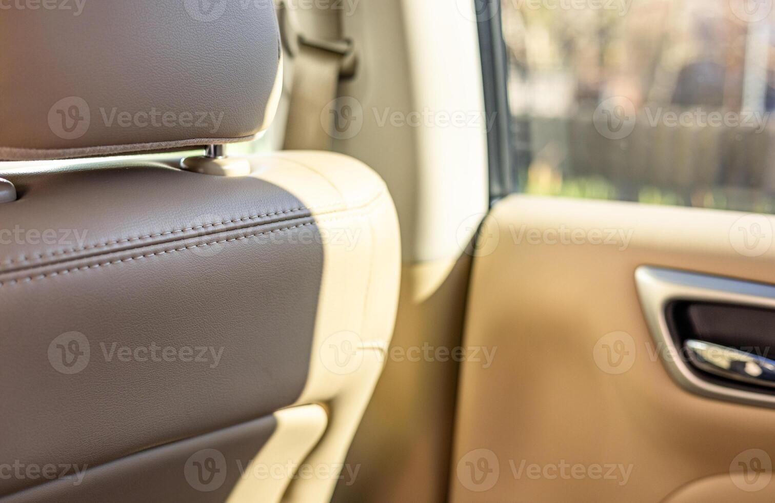 The back seat of a car is shown with a leather seat photo