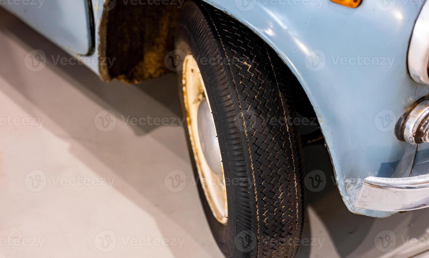A close up of a blue car with a tire photo