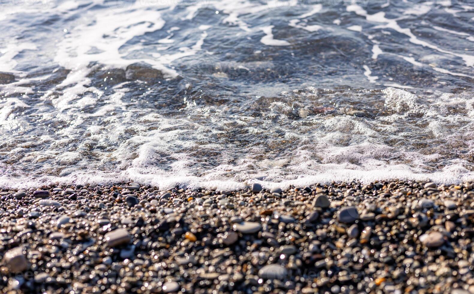 A beach with waves and rocks photo
