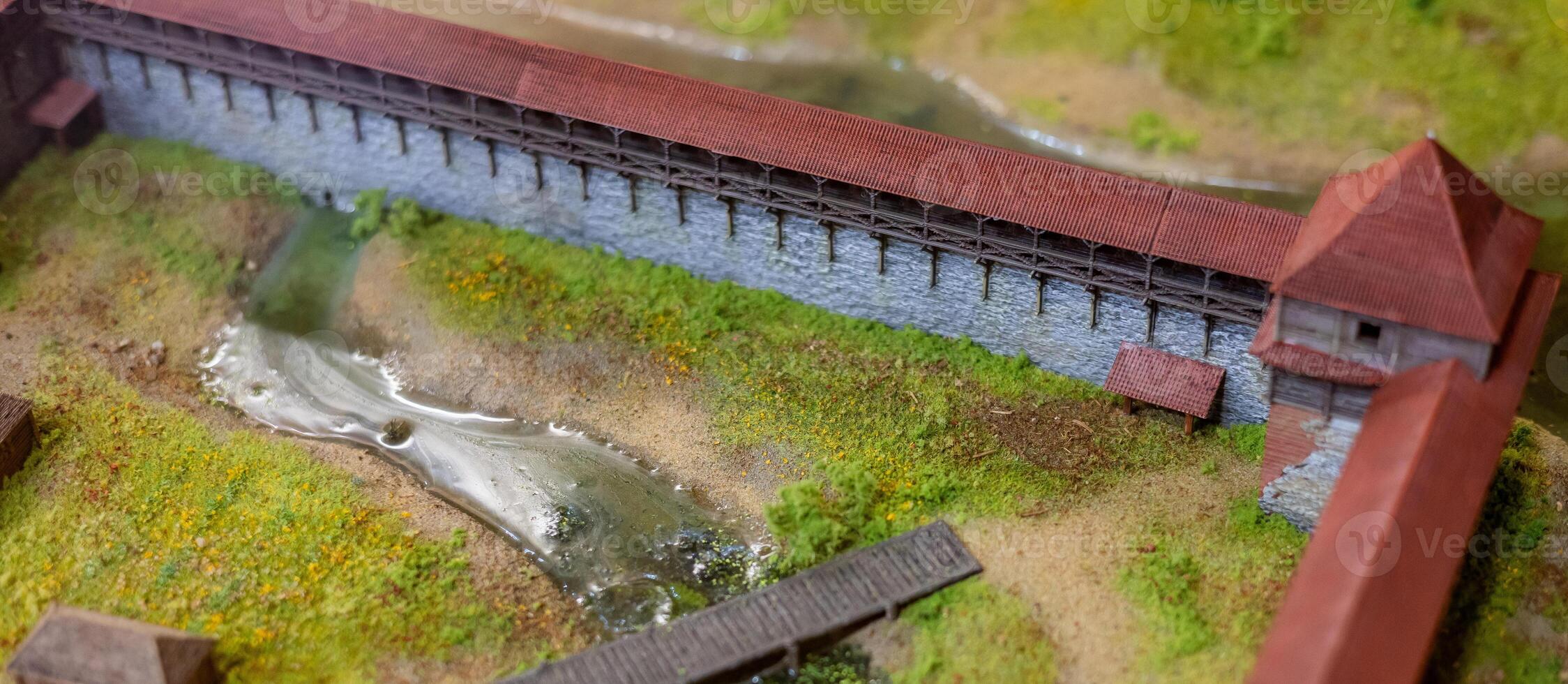 A model of a bridge with a small stream running through it photo
