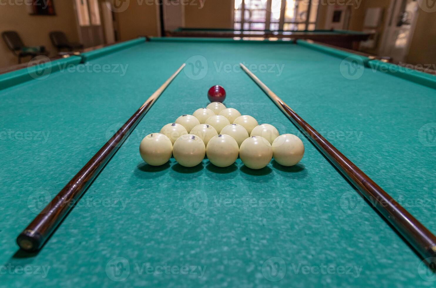 A pool table with balls and sticks on it photo