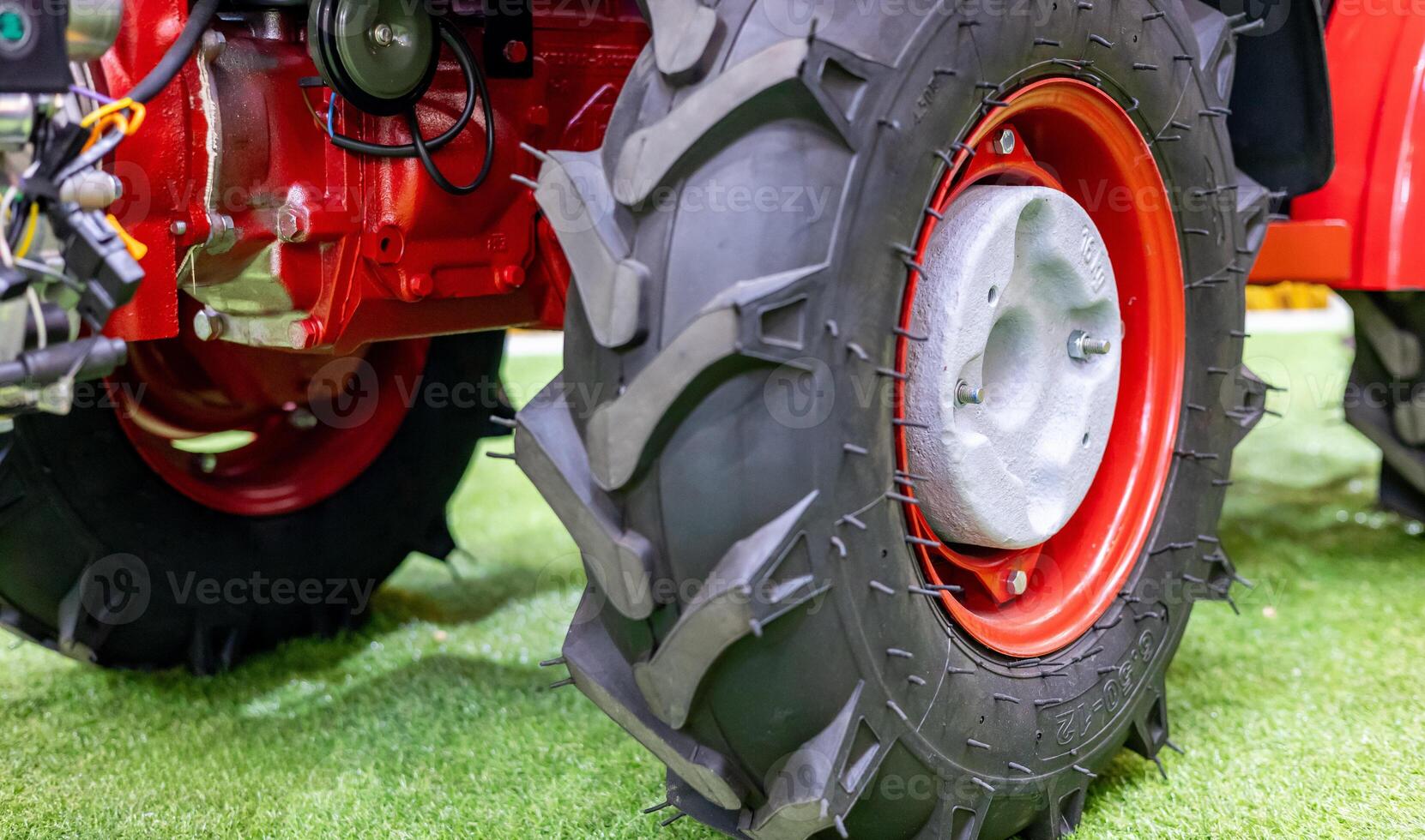 A close up of a tractor tire on grass photo