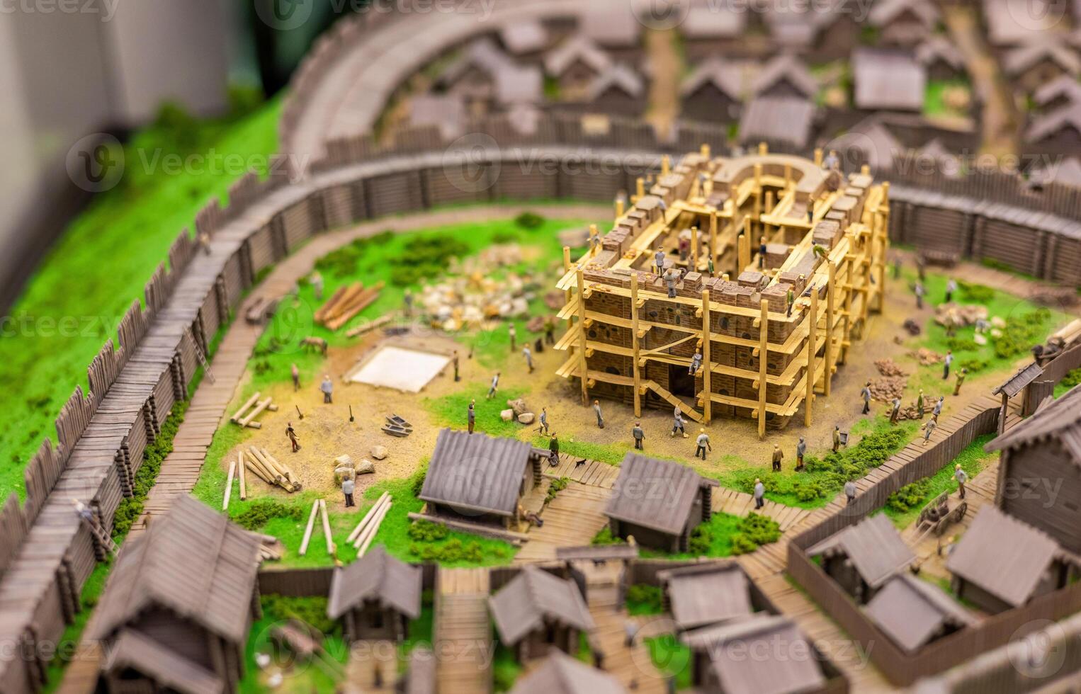 A model of a medieval town with people and buildings photo