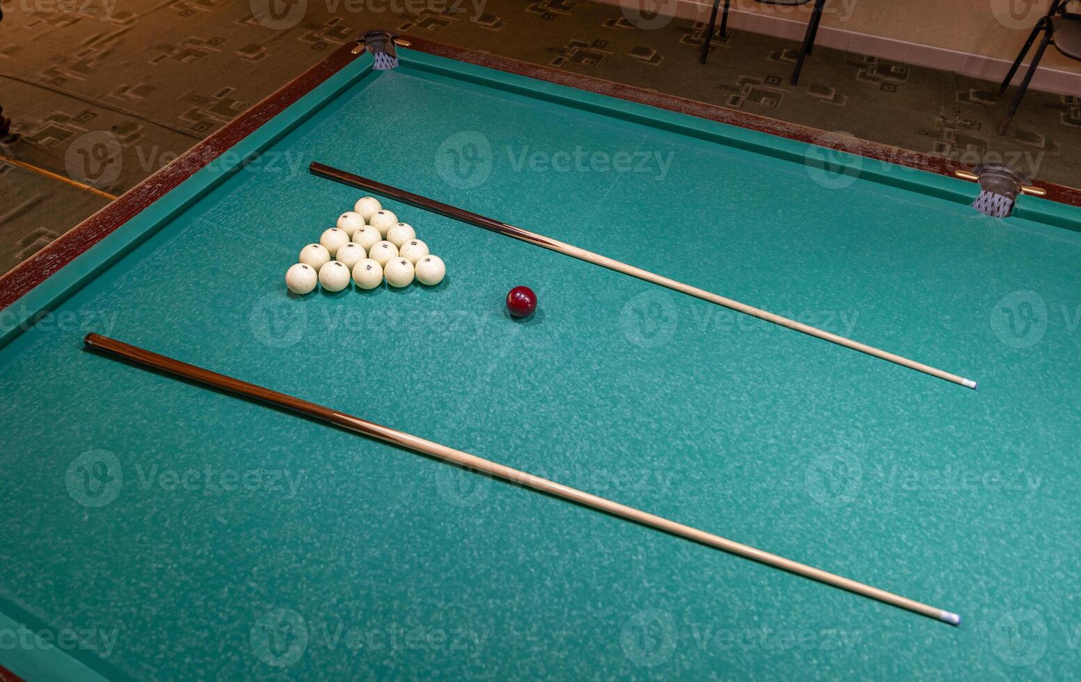 A pool table with two balls and a cue ball photo