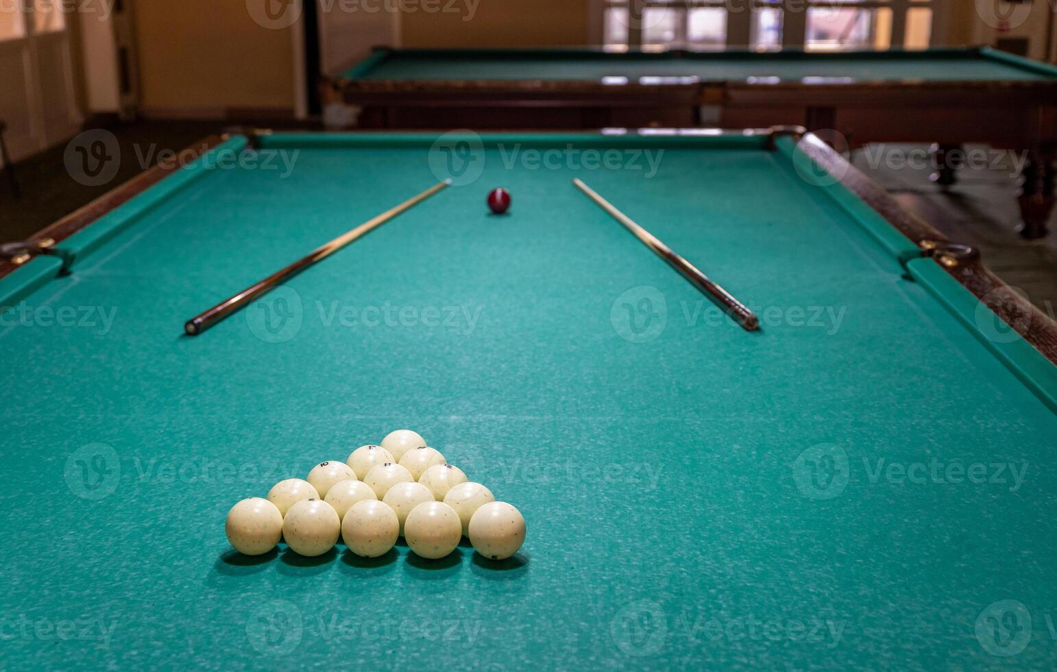A pool table with a green cloth and a ball photo