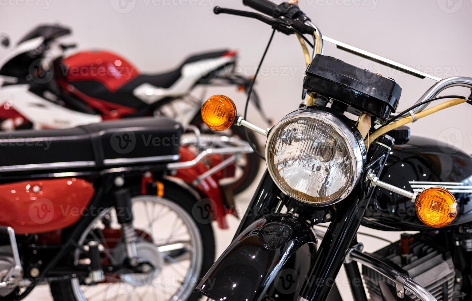A row of motorcycles parked in a room photo