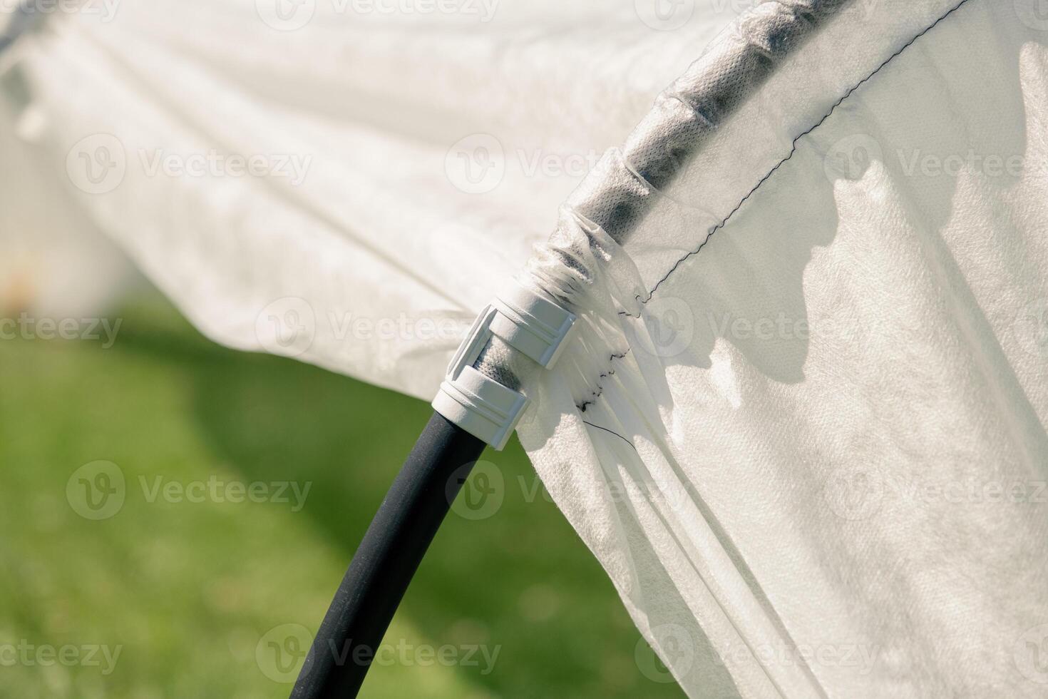 A close up of a tent with a black pole photo