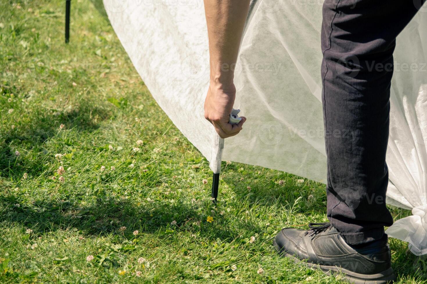 A person is standing next to a tent photo