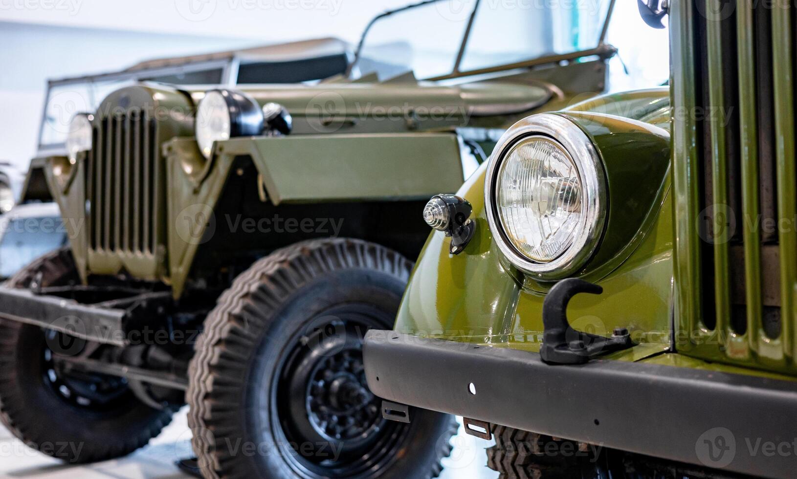 A close up of two jeeps parked in a garage photo