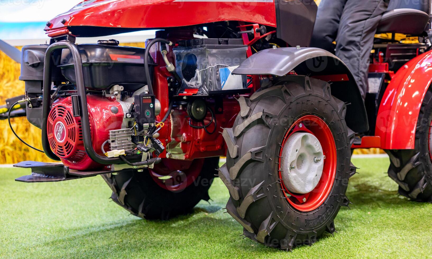 A red tractor with a large engine on display photo