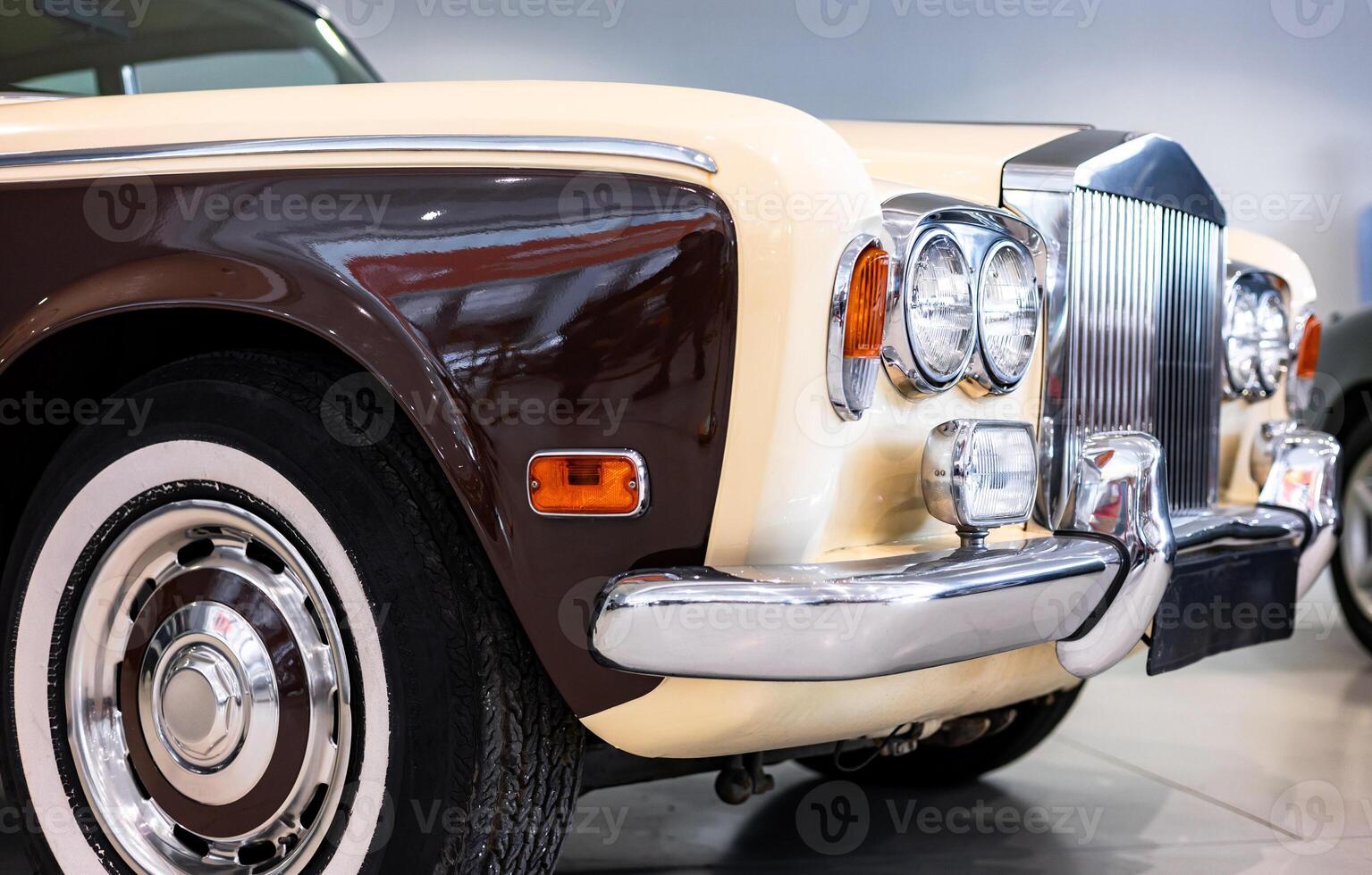A classic car is parked in a showroom photo