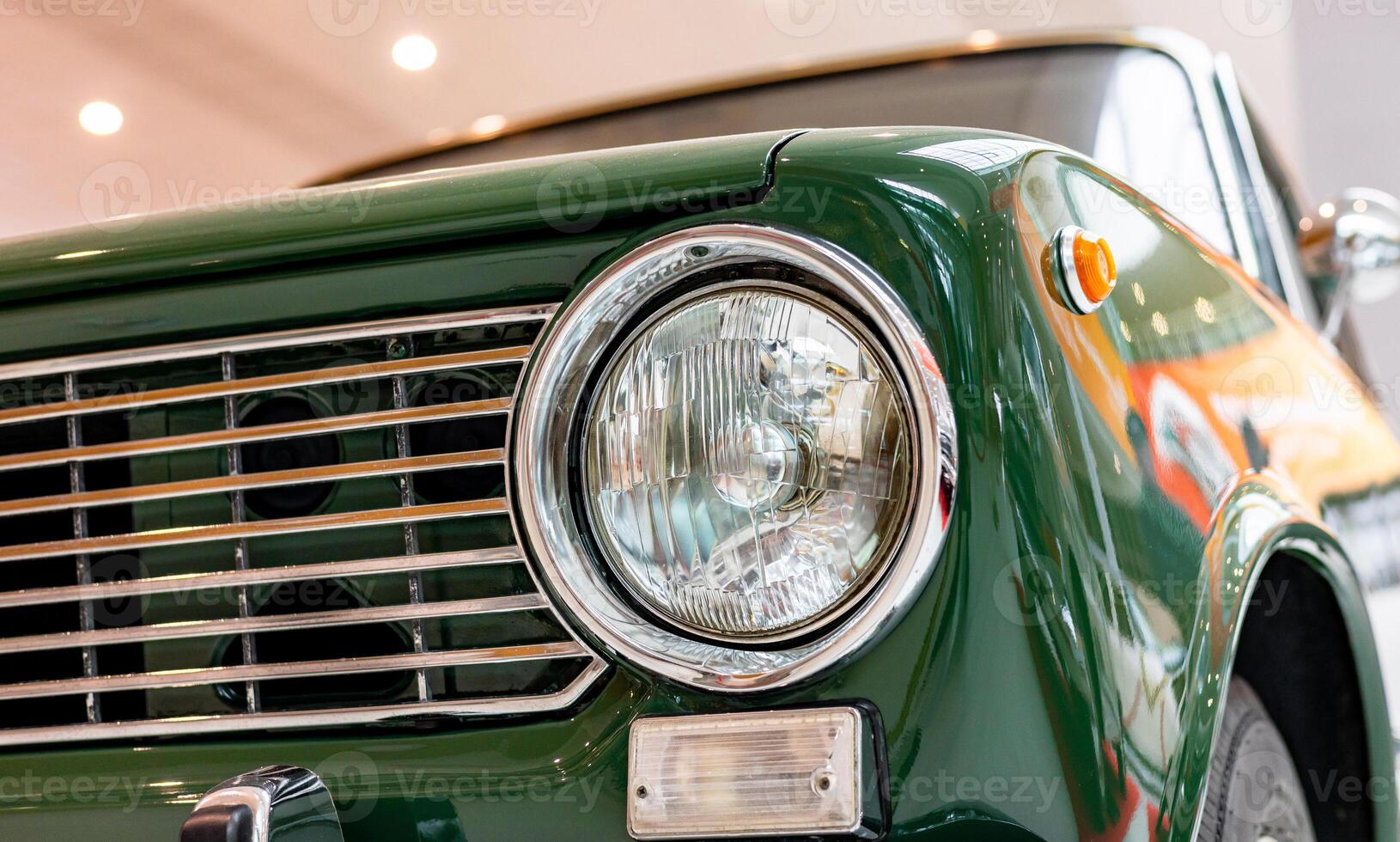 A close up of a green car with a headlight photo