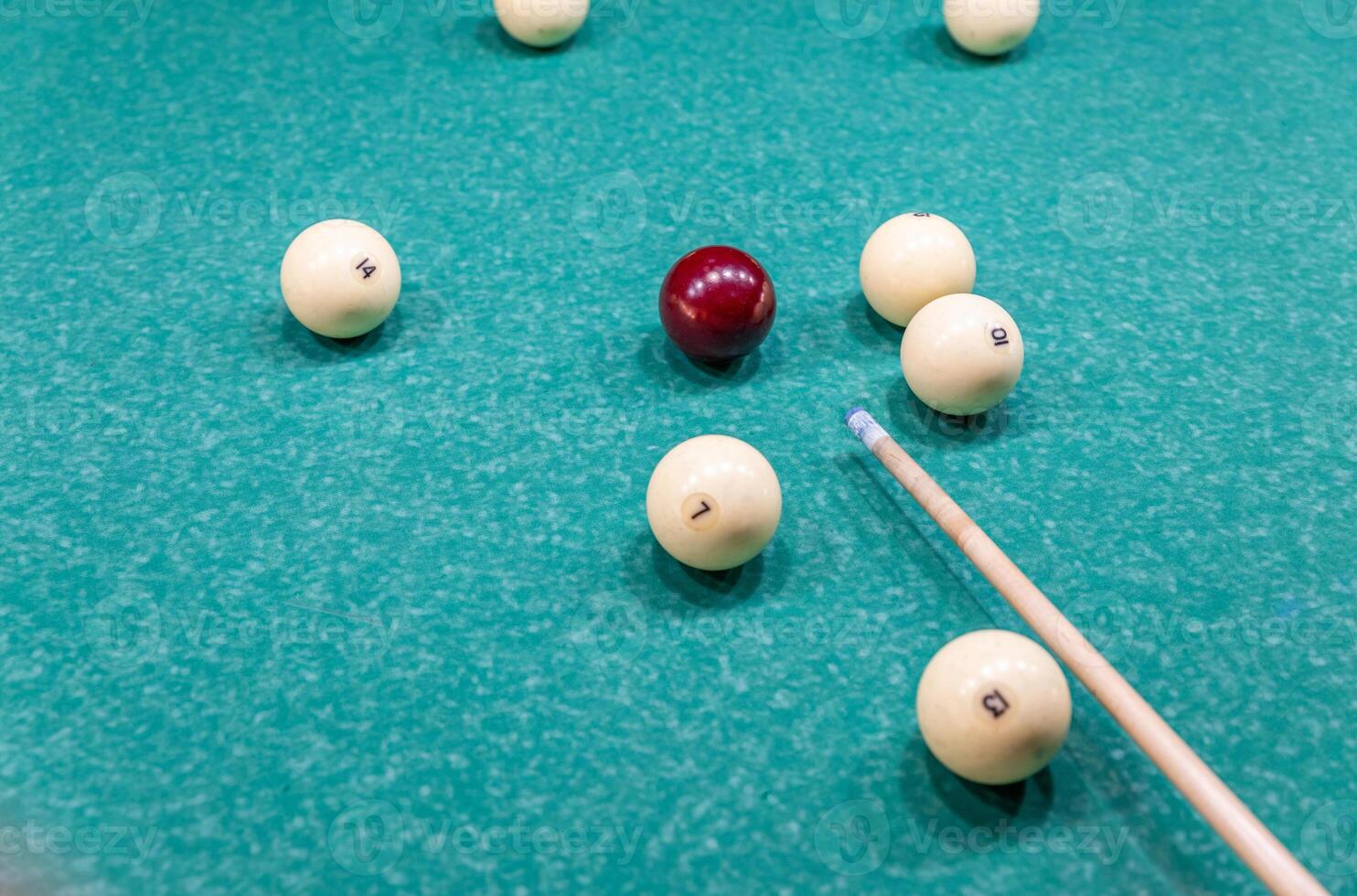 Billiard balls on a pool table with a stick photo