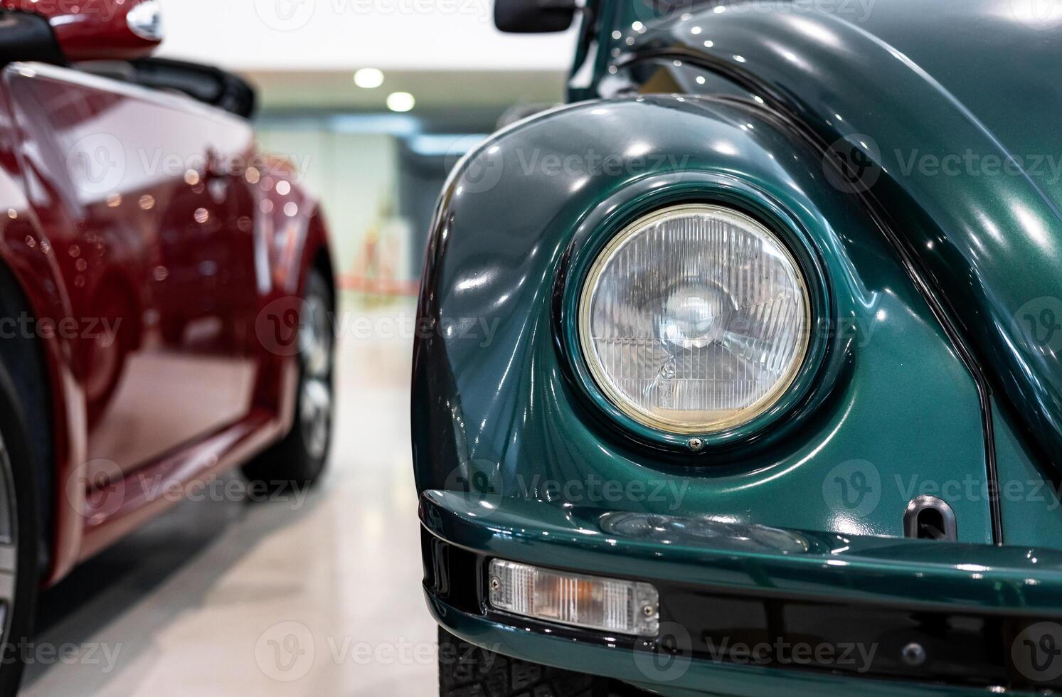 A close up of two green and red vw beetles photo