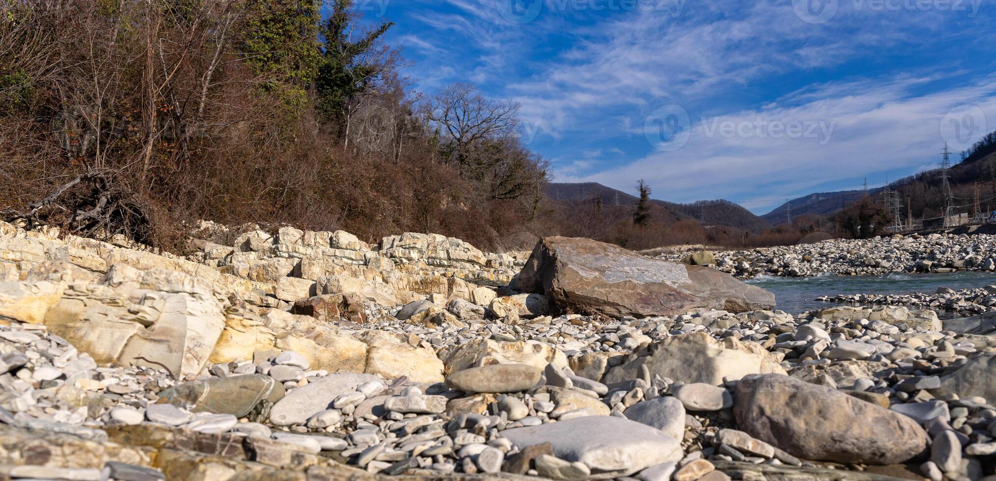 A river with rocks and trees in the foreground photo