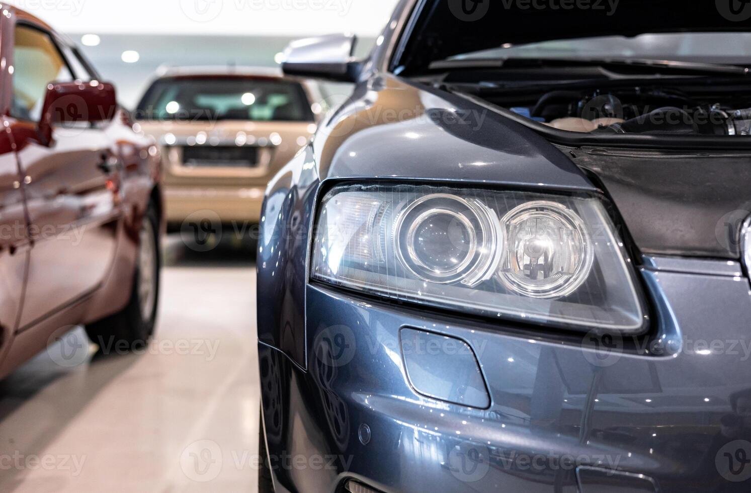A car dealership with many cars in the showroom photo