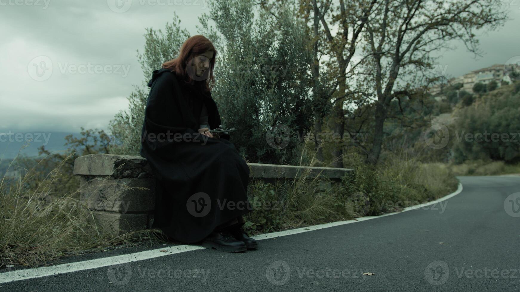 Christian Woman Prays With Crucifix Sitting Beside A Road In Nature Outdoor photo