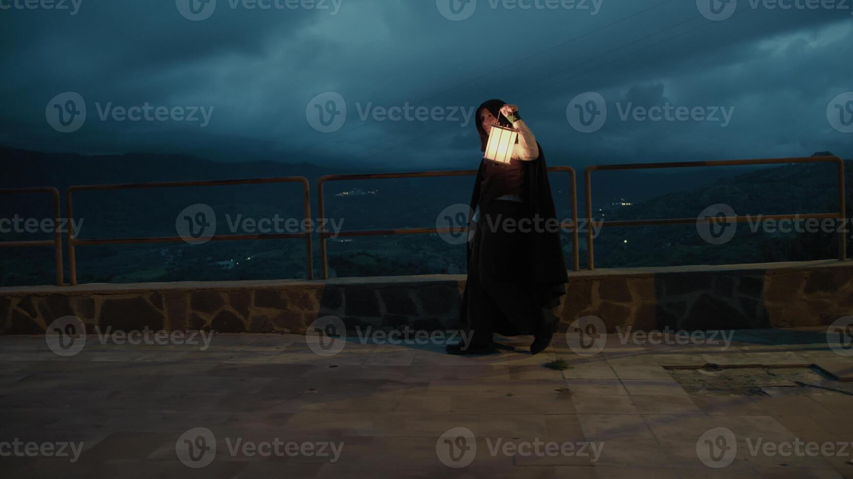 Enigmatic Woman Walks With A Lantern In Her Hand At Night In Mountains photo
